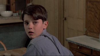 Movie still from “Places in the Heart” (1984), directed by Robert Benton – A young boy is looking into the distance; Close Up shot, Over the shoulder angle