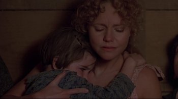 Movie still from “Places in the Heart” (1984), directed by Robert Benton – A woman holding a child in her arms; Close Up shot, Over the shoulder angle