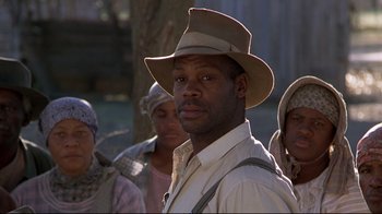 Movie still from “Places in the Heart” (1984), directed by Robert Benton – A group of people standing next to each other wearing hats; Close Up shot, Low angle