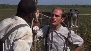 Movie still from “Places in the Heart” (1984), directed by Robert Benton – A man is tying a rope to another man's face; Medium shot, Low angle