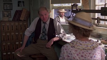 Movie still from “Places in the Heart” (1984), directed by Robert Benton – Two men and a woman sitting at a table in front of a window; Medium shot, Over the shoulder angle