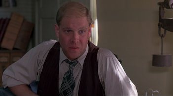 Movie still from “Places in the Heart” (1984), directed by Robert Benton – A person wearing a vest and a tie; Close Up shot, Low angle