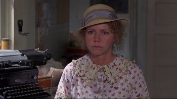 Movie still from “Places in the Heart” (1984), directed by Robert Benton – A woman in a hat and a butterfly print dress; Close Up shot, Over the shoulder angle