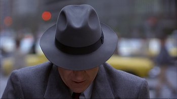 Movie still from “Planes, Trains & Automobiles” (1987), directed by John Hughes – A person wearing a hat; Close Up shot, Over the shoulder angle