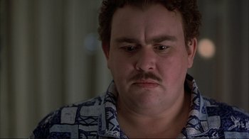 Movie still from “Planes, Trains & Automobiles” (1987), directed by John Hughes – A person with a beard and mustache; Close Up shot, Low angle