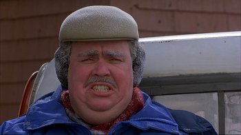 Movie still from “Planes, Trains & Automobiles” (1987), directed by John Hughes – A person wearing a hat and jacket; Close Up shot, Low angle