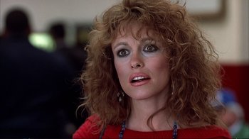 Movie still from “Planes, Trains & Automobiles” (1987), directed by John Hughes – A person wearing a red shirt; Close Up shot, Over the shoulder angle