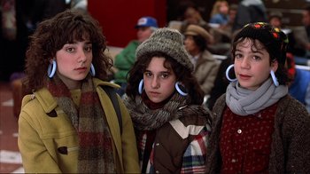 Movie still from “Planes, Trains & Automobiles” (1987), directed by John Hughes – A group of young girls standing next to each other; Medium shot, Low angle