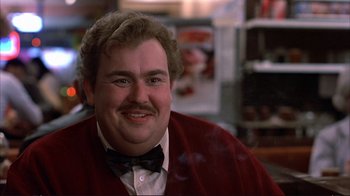 Movie still from “Planes, Trains & Automobiles” (1987), directed by John Hughes – A person with a mustache wearing a bow tie; Close Up shot, Low angle