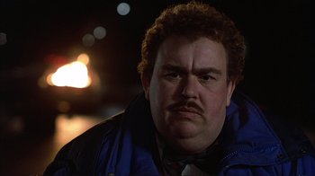 Movie still from “Planes, Trains & Automobiles” (1987), directed by John Hughes – A person wearing a jacket and a bow tie; Close Up shot, Low angle