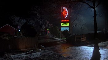 Movie still from “Planes, Trains & Automobiles” (1987), directed by John Hughes – A motel sign is lit up at night; Wide shot, Low angle
