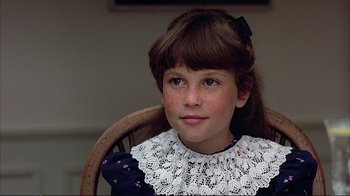 Movie still from “Planes, Trains & Automobiles” (1987), directed by John Hughes – A young girl wearing a white lace collar; Close Up shot, High angle