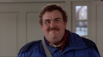 Movie still from “Planes, Trains & Automobiles” (1987), directed by John Hughes – A person wearing a jacket and a scarf; Close Up shot, Low angle
