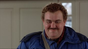 Movie still from “Planes, Trains & Automobiles” (1987), directed by John Hughes – A person wearing a blue jacket; Close Up shot, Low angle
