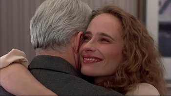 Movie still from “Planes, Trains & Automobiles” (1987), directed by John Hughes – A man and a woman hugging and smiling; Close Up shot, Over the shoulder angle