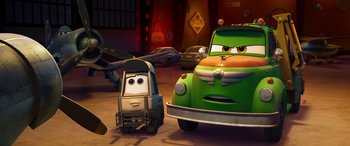 Movie still from “Planes: Fire & Rescue” (2014), directed by Bobs Gannaway – A green truck and a green car in a garage; Wide shot, Low angle