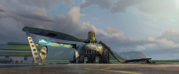 Movie still from “Planes: Fire & Rescue” (2014), directed by Bobs Gannaway – An airplane that is sitting on a runway; Extreme Wide shot, Low angle