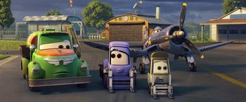 Movie still from “Planes: Fire & Rescue” (2014), directed by Bobs Gannaway – A group of cartoon cars parked next to each other on a street; Wide shot, Low angle