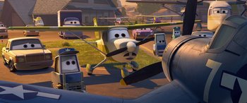 Movie still from “Planes: Fire & Rescue” (2014), directed by Bobs Gannaway – An airplane is parked on the grass near other vehicles; Wide shot, Low angle