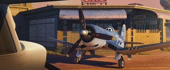 Movie still from “Planes: Fire & Rescue” (2014), directed by Bobs Gannaway – An airplane is parked in front of a building; Wide shot, Low angle