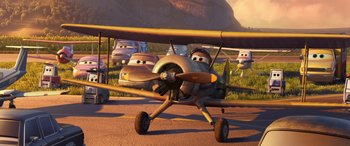 Movie still from “Planes: Fire & Rescue” (2014), directed by Bobs Gannaway – An airplane with cars in the background is shown; Wide shot, Low angle