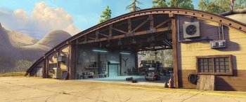 Movie still from “Planes: Fire & Rescue” (2014), directed by Bobs Gannaway – An artist's rendering of a garage with a car parked in front of it; Extreme Wide shot, High angle
