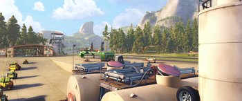 Movie still from “Planes: Fire & Rescue” (2014), directed by Bobs Gannaway – An animated scene of an airport with a plane and an airplane; Extreme Wide shot, High angle