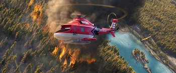 Movie still from “Planes: Fire & Rescue” (2014), directed by Bobs Gannaway – A red and white helicopter flying through the air near a forest fire; Extreme Wide shot, High angle