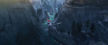 Movie still from “Planes: Fire & Rescue” (2014), directed by Bobs Gannaway – An airplane is flying over a valley in the mountains; Extreme Wide shot, Overhead angle