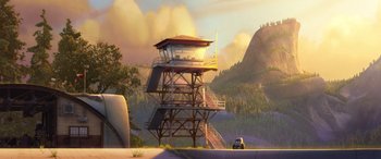Movie still from “Planes: Fire & Rescue” (2014), directed by Bobs Gannaway – An animated scene of a tower with a car in front of it; Extreme Wide shot, Low angle