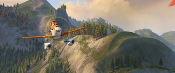 Movie still from “Planes: Fire & Rescue” (2014), directed by Bobs Gannaway – An airplane is flying over a mountain with trees; Extreme Wide shot, Low angle