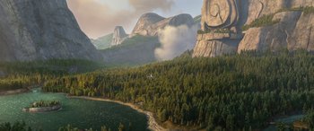 Movie still from “Planes: Fire & Rescue” (2014), directed by Bobs Gannaway – An airplane flying over a body of water near mountains; Extreme Wide shot, High angle