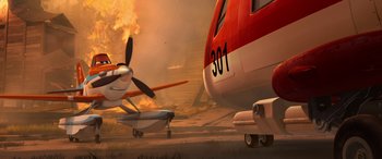 Movie still from “Planes: Fire & Rescue” (2014), directed by Bobs Gannaway – An airplane that is on fire in the air; Wide shot, Low angle