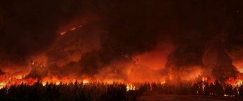 Movie still from “Planes: Fire & Rescue” (2014), directed by Bobs Gannaway – A large fire burning in the middle of a forest at night; Extreme Wide shot, High angle