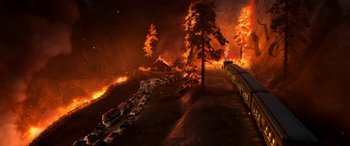 Movie still from “Planes: Fire & Rescue” (2014), directed by Bobs Gannaway – Cars are parked on the side of the road as a fire rages in the background; Extreme Wide shot, High angle