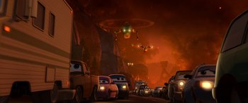 Movie still from “Planes: Fire & Rescue” (2014), directed by Bobs Gannaway – A group of cars driving down a street at night; Extreme Wide shot, Low angle