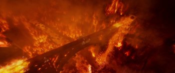 Movie still from “Planes: Fire & Rescue” (2014), directed by Bobs Gannaway – An aerial view of a burning city with cars on the road; Extreme Wide shot, High angle