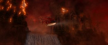 Movie still from “Planes: Fire & Rescue” (2014), directed by Bobs Gannaway – A helicopter is flying over a waterfall on fire; Extreme Wide shot, High angle