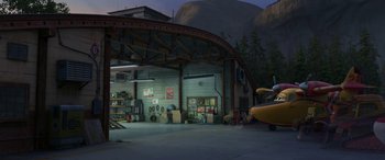 Movie still from “Planes: Fire & Rescue” (2014), directed by Bobs Gannaway – An airplane is parked in a hangar near a mountain; Extreme Wide shot, High angle