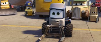 Movie still from “Planes: Fire & Rescue” (2014), directed by Bobs Gannaway – A silver and black car is in a parking lot; Wide shot, Low angle