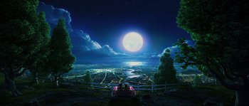 Movie still from “Planet 51” (2009), directed by Javier Abad – A view of a city at night with a full moon in the background; Extreme Wide shot, High angle