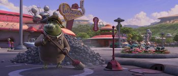 Movie still from “Planet 51” (2009), directed by Javier Abad – A cartoon character sweeping the street in front of a building; Wide shot, High angle