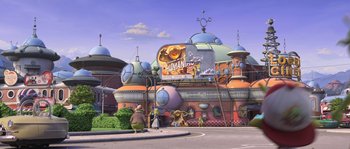 Movie still from “Planet 51” (2009), directed by Javier Abad – An animated scene of a building with a person standing on it; Extreme Wide shot, High angle