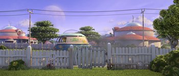 Movie still from “Planet 51” (2009), directed by Javier Abad – An old vw van is parked in the grass near a white picket fence; Extreme Wide shot, Low angle