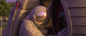 Movie still from “Planet 51” (2009), directed by Javier Abad – An image of a person in a spacesuit looking at the sunset; Wide shot, Overhead angle