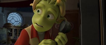 Movie still from “Planet 51” (2009), directed by Javier Abad – A green cartoon character holding a microphone in his hand; Close Up shot, High angle