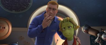 Movie still from “Planet 51” (2009), directed by Javier Abad – A man standing next to a woman with a green face; Medium shot, Over the shoulder angle