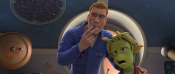 Movie still from “Planet 51” (2009), directed by Javier Abad – An animated man in a blue suit next to a green monster; Medium shot, Over the shoulder angle