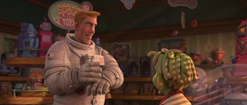 Movie still from “Planet 51” (2009), directed by Javier Abad – A man in a spaceman suit is holding a banana; Medium shot, Over the shoulder angle