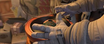 Movie still from “Planet 51” (2009), directed by Javier Abad – A person in a white glove is holding a record; Extreme Close Up shot, Overhead angle